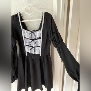 Black Gothic Lolita medium length dress with puffy sleeves and white lace design